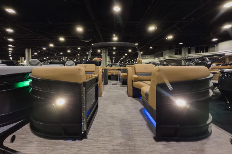 Slide: The Image of 2026 Godfrey Monaco 235 Ultra Lounge pontoon boat interior at a boat show. - 2