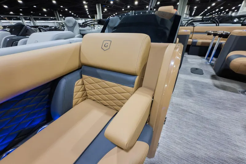 Slide: The Image of Luxurious seating on 2026 Godfrey Monaco 235 Ultra Lounge boat, featuring elegant tan and blue upholstery. - 5
