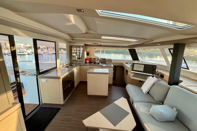 Slide: The Image of Luxurious interior of 2018 Fountaine Pajot Saona catamaran with modern kitchen and seating area. - 13