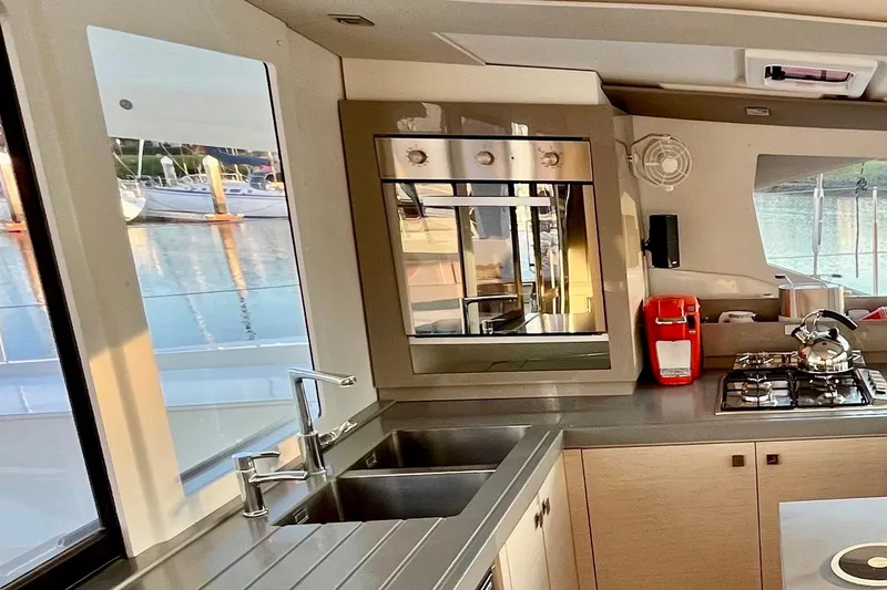 Slide: The Image of Modern kitchen interior of 2018 Fountaine Pajot Saona catamaran with appliances and scenic window view. - 15