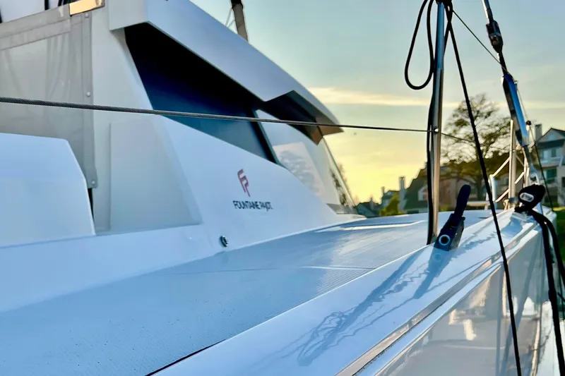 Slide: The Image of 2018 Fountaine Pajot Saona catamaran deck at sunset, showcasing sleek design and modern features. - 3