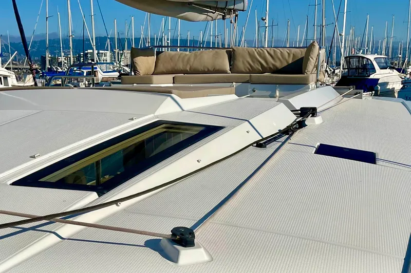 Slide: The Image of 2018 Fountaine Pajot Saona catamaran deck with seating, docked in marina. - 8