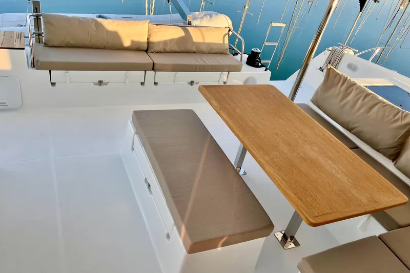 Slide: The Image of 2018 Fountaine Pajot Saona yacht deck with cushioned seating and wooden table. - 11