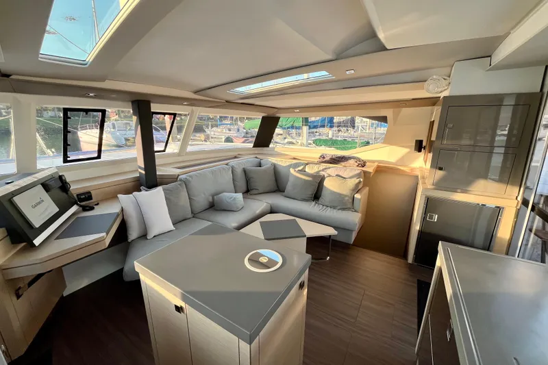 Slide: The Image of Luxurious interior of 2018 Fountaine Pajot Saona catamaran with modern seating and navigation equipment. - 12