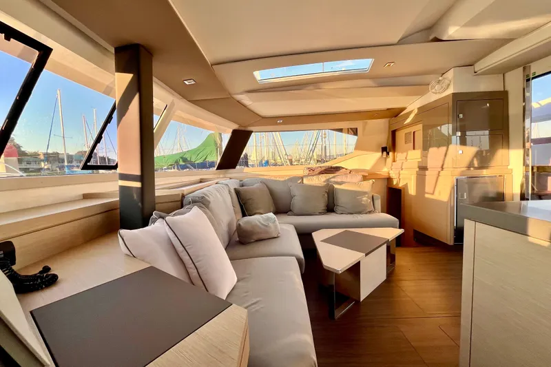 Slide: The Image of Luxurious interior of 2018 Fountaine Pajot Saona catamaran with modern furnishings and panoramic windows. - 16