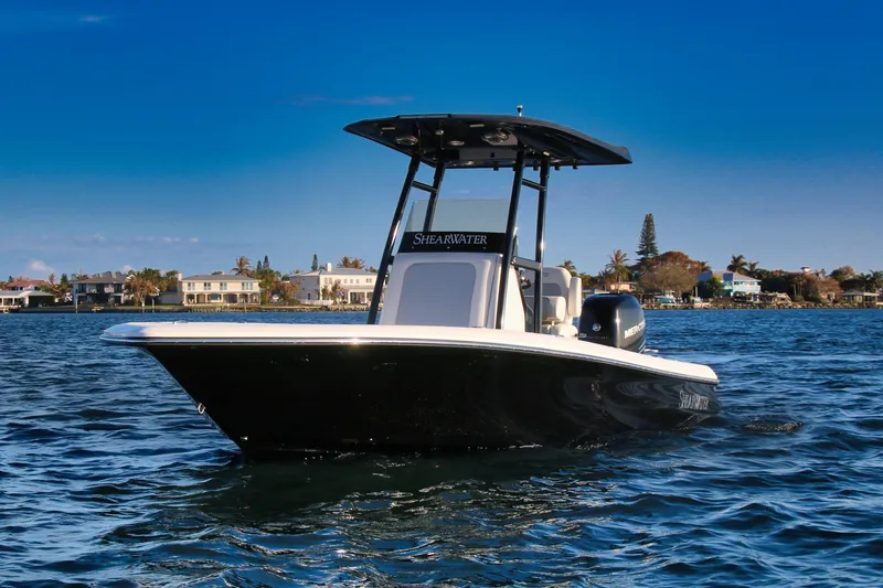 The Image of 2023 ShearWater 260 SS Carolina boat on calm water with coastal homes in background. - 0