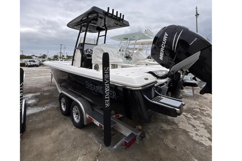 Slide: The Image of 2023 ShearWater 260 SS Carolina boat on calm water under blue sky. - 1