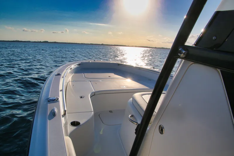 Slide: The Image of 2023 ShearWater 260 SS Carolina boat on calm water at sunset. - 10
