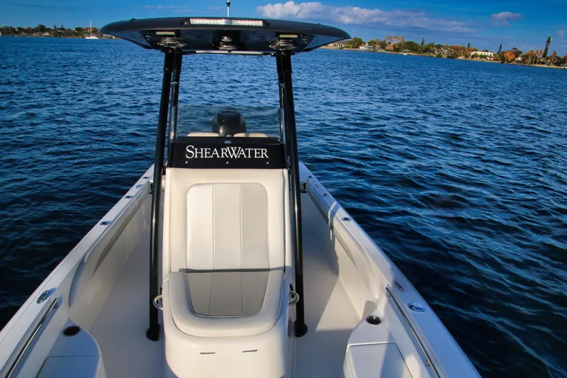 Slide: The Image of 2023 ShearWater 260 SS Carolina boat on calm blue water. - 13