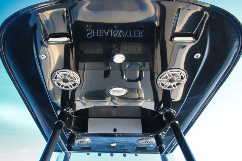 Slide: The Image of 2023 ShearWater 260 SS Carolina boat, underside view with speakers and sleek design. - 16