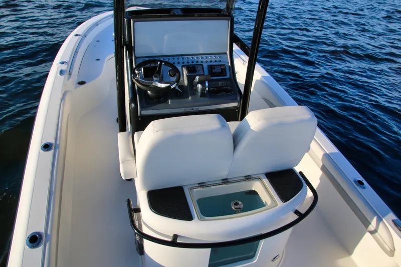 Slide: The Image of 2023 ShearWater 260 SS Carolina boat interior with helm and seating on water. - 18