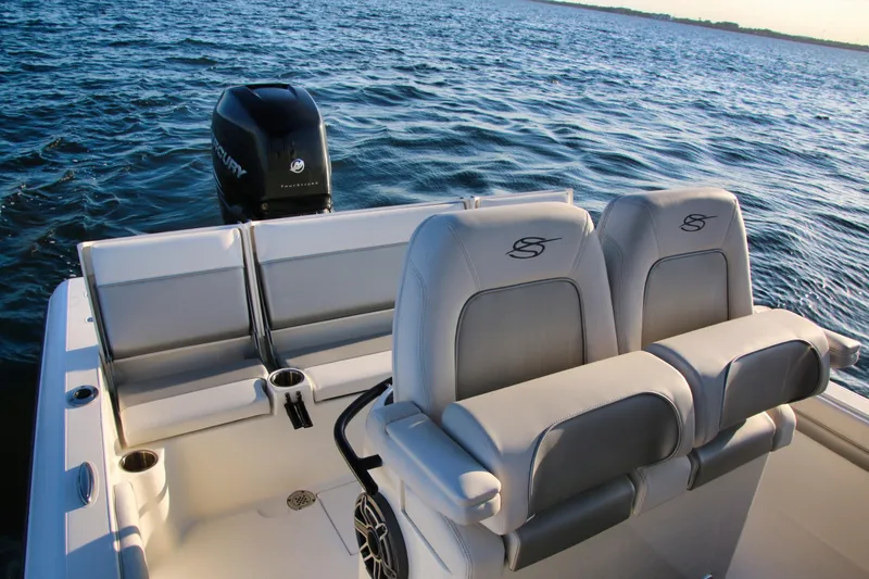 Slide: The Image of 2023 ShearWater 260 SS Carolina boat interior with seating and Mercury engine on water. - 19