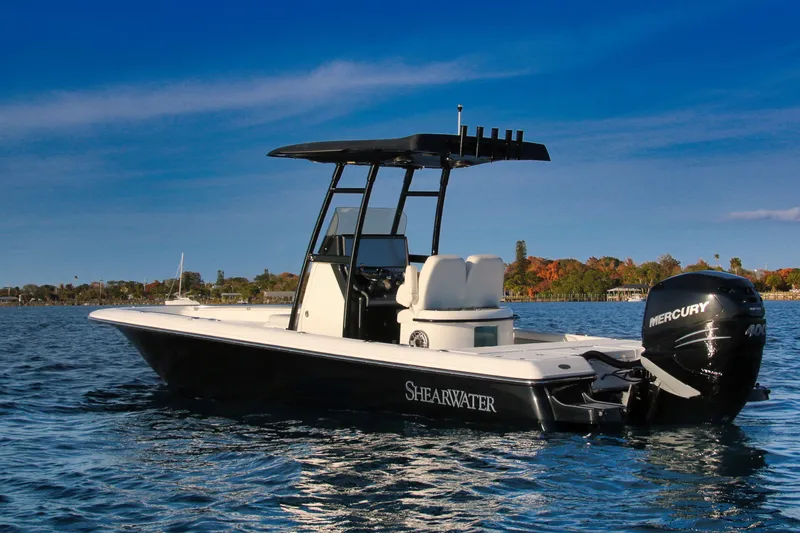 Slide: The Image of 2023 ShearWater 260 SS Carolina boat on calm water with Mercury engine. - 23