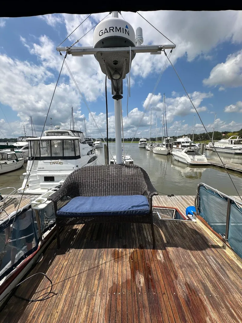 Slide: The Image of 1974 Grand Banks 32 Sedan on a sunny marina, featuring a Garmin radar and seating area. - 10