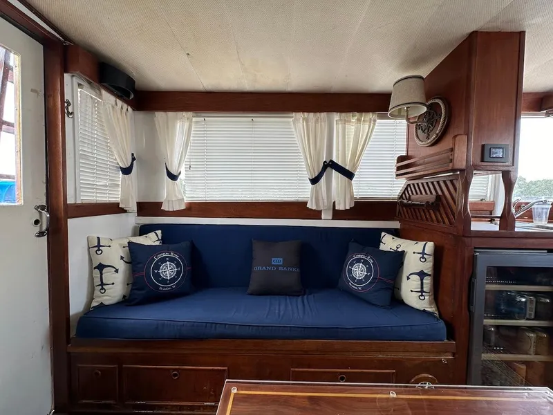 Slide: The Image of Interior of 1974 Grand Banks 32 Sedan with nautical-themed decor and blue seating. - 21