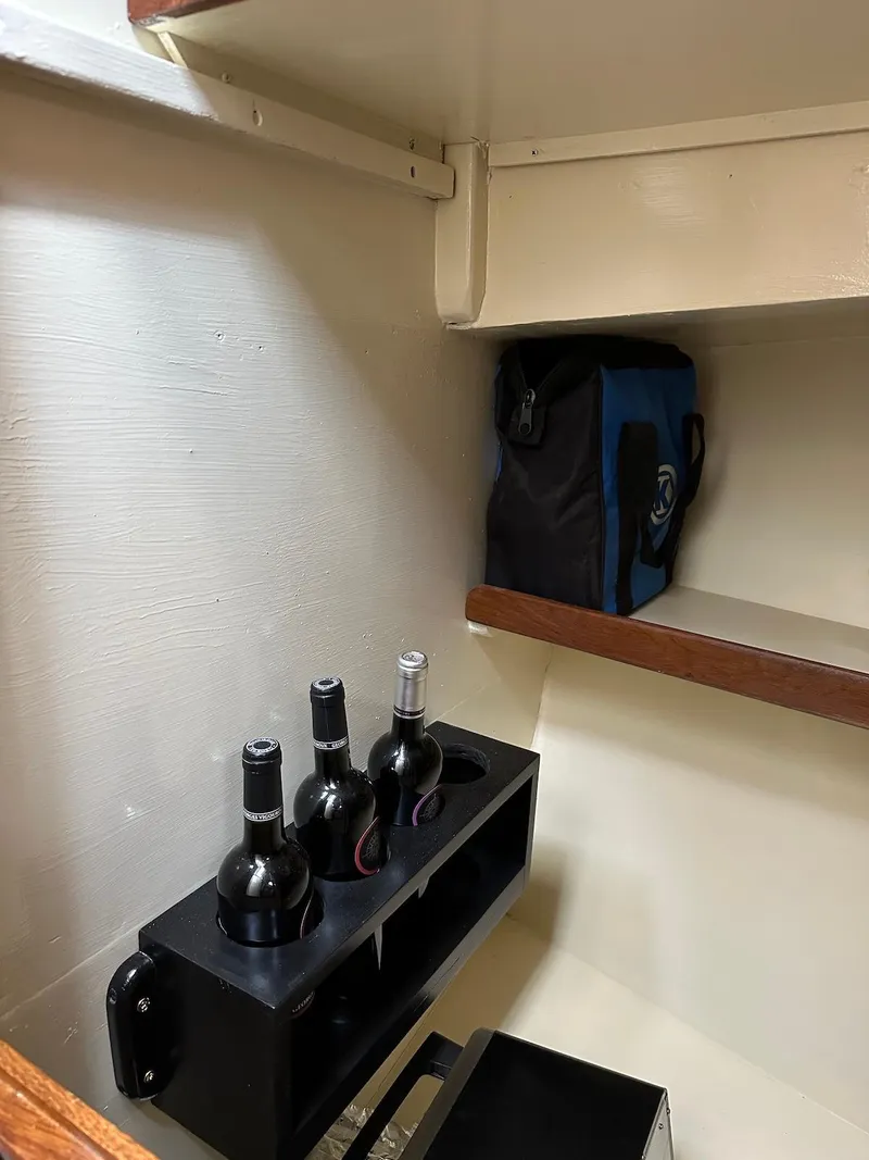 Slide: The Image of Interior of 1974 Grand Banks 32 Sedan with wine bottles and storage bag. - 28