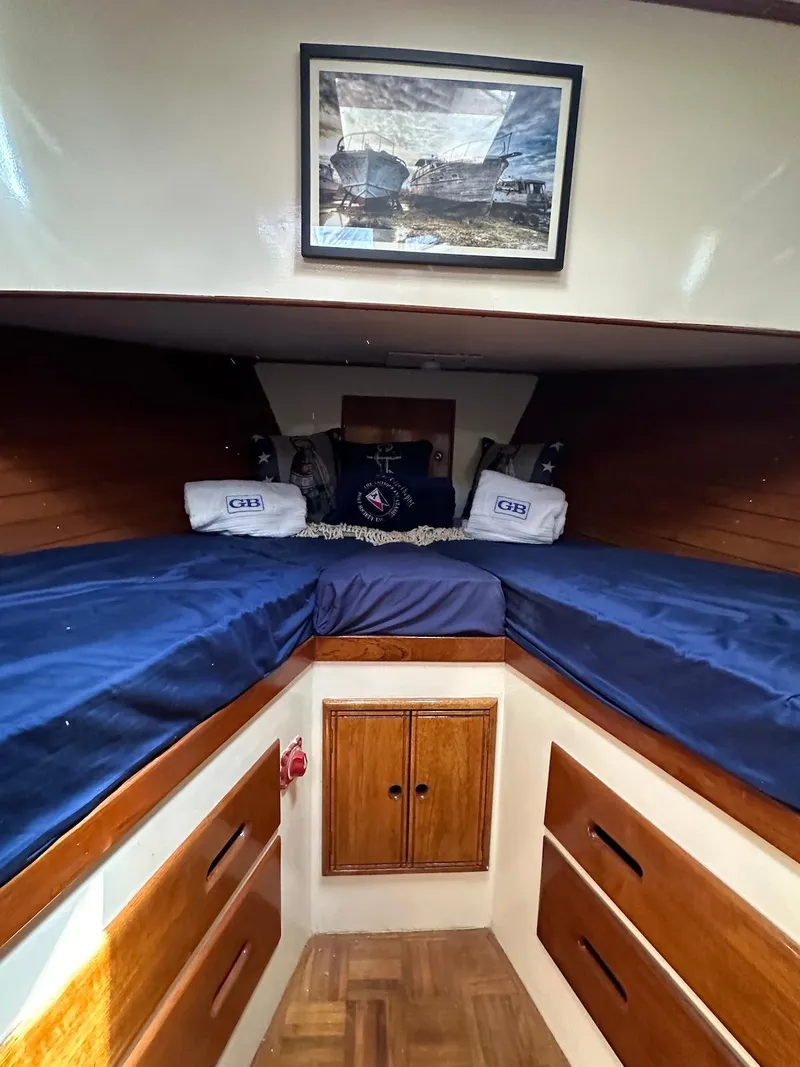 Slide: The Image of Interior of a 1974 Grand Banks 32 Sedan with twin beds and wooden cabinetry. - 31