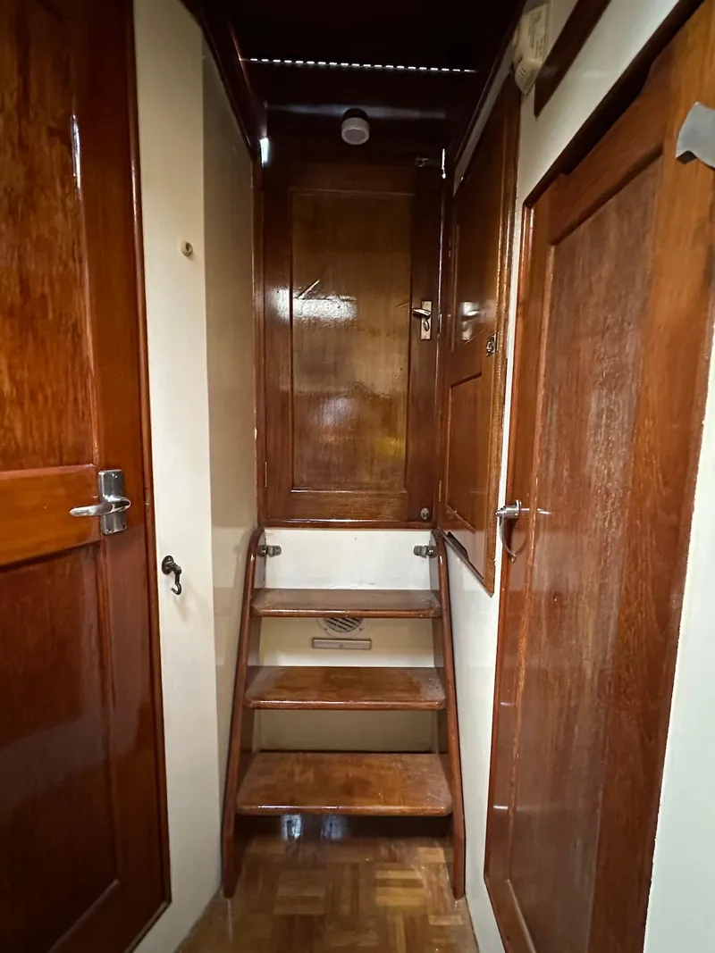 Slide: The Image of Interior of a 1974 Grand Banks 32 Sedan with wooden stairs and doors. - 36
