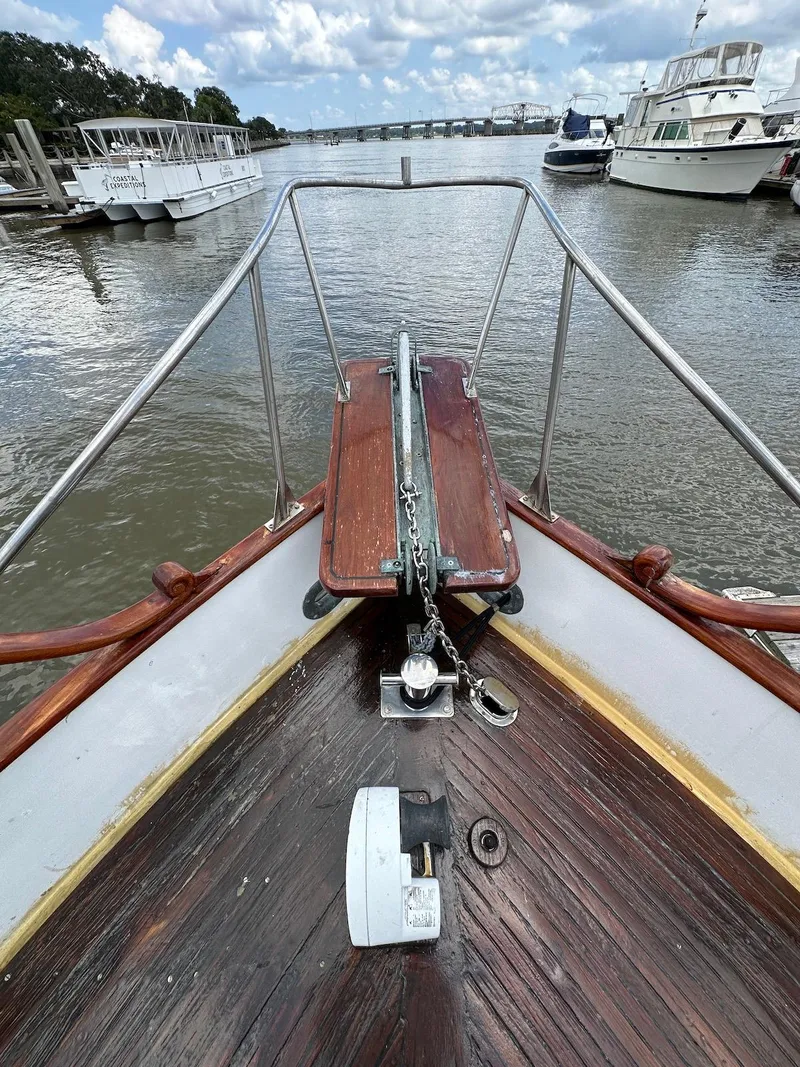 Slide: The Image of 1974 Grand Banks 32 Sedan boat bow with anchor, docked in a marina. - 4