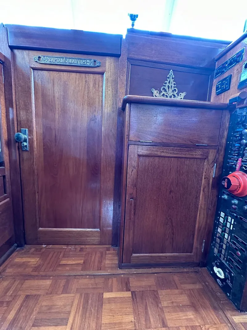 Slide: The Image of Interior of a 1974 Grand Banks 32 Sedan with wooden cabinetry and parquet flooring. - 43