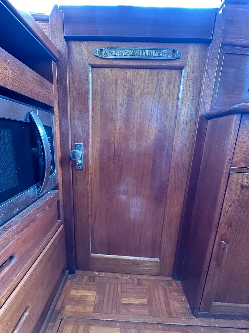 Slide: The Image of Interior of 1974 Grand Banks 32 Sedan with wooden cabinetry and door. - 44
