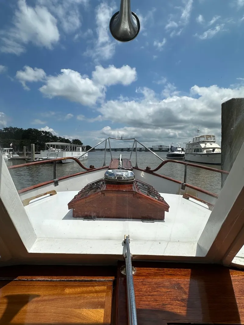Slide: The Image of 1974 Grand Banks 32 Sedan boat view from cabin, docked under a partly cloudy sky. - 46