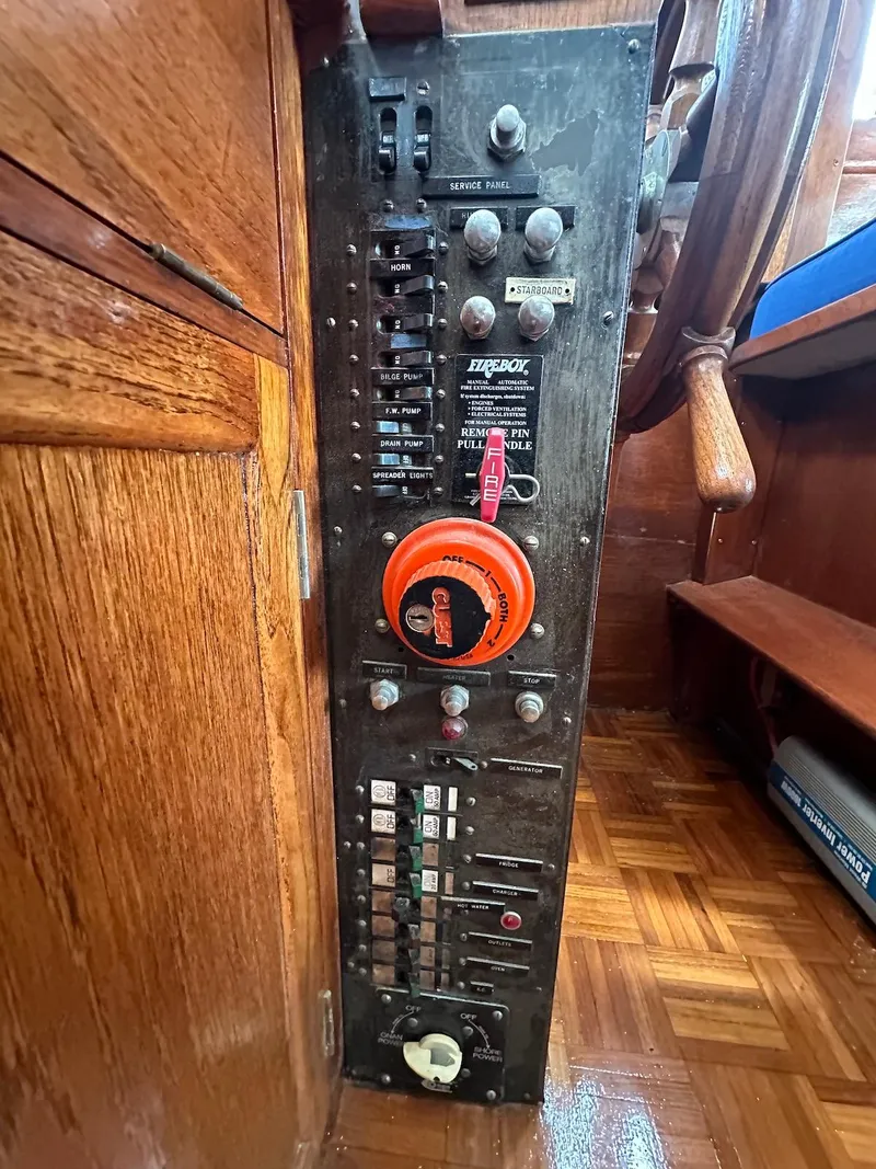 Slide: The Image of Electrical panel of a 1974 Grand Banks 32 Sedan boat, featuring switches and controls. - 48
