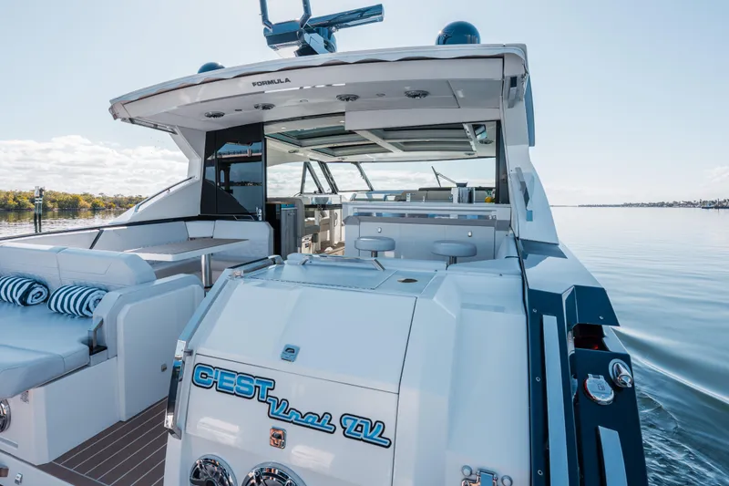 Slide: The Image of 2022 Formula 500 Super Sport Crossover yacht on calm water, featuring luxurious seating and modern design. - 17