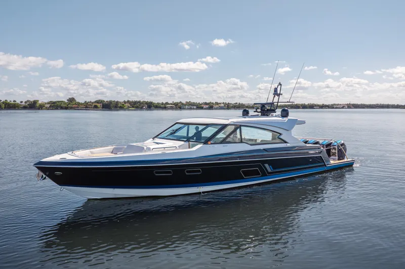 Slide: The Image of 2022 Formula 500 Super Sport Crossover yacht on calm water under blue sky. - 2