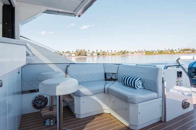 Slide: The Image of Luxurious seating area on 2022 Formula 500 Super Sport Crossover yacht, overlooking serene waters. - 21