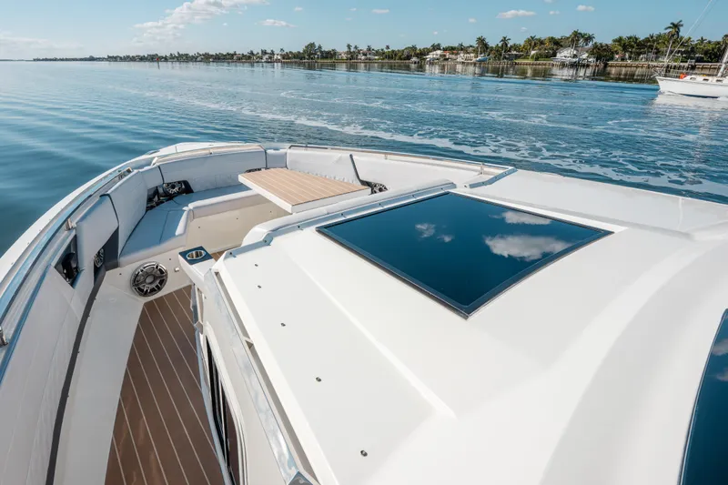 Slide: The Image of 2022 Formula 500 Super Sport Crossover boat on calm water, showcasing luxury deck design. - 3