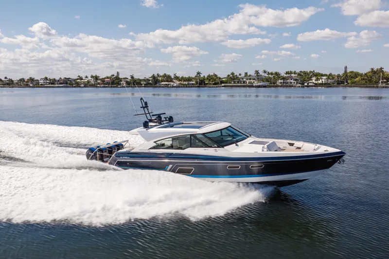 Slide: The Image of 2022 Formula 500 Super Sport Crossover cruising on a calm lake under a blue sky. - 5