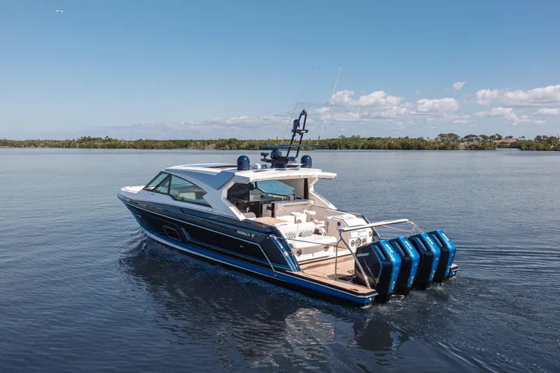 Slide: The Image of 2022 Formula 500 Super Sport Crossover boat cruising on calm water under a clear sky. - 6