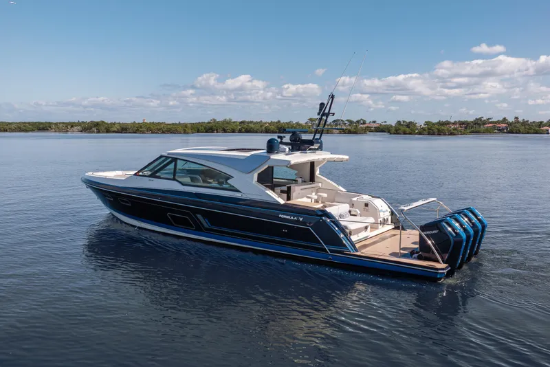 Slide: The Image of 2022 Formula 500 Super Sport Crossover boat on calm water under blue sky. - 7
