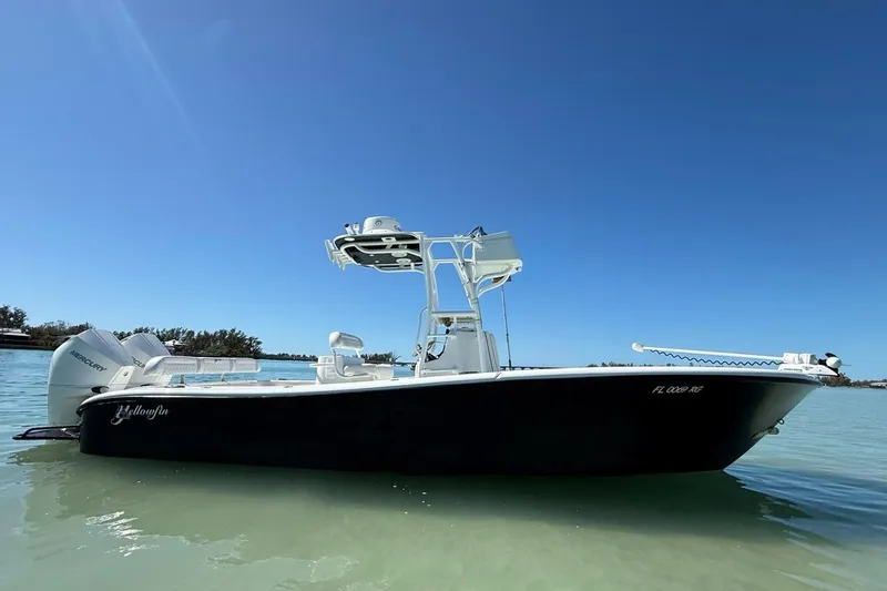 The Image of 2017 Yellowfin 26 Hybrid boat on calm water under clear blue sky. - 1