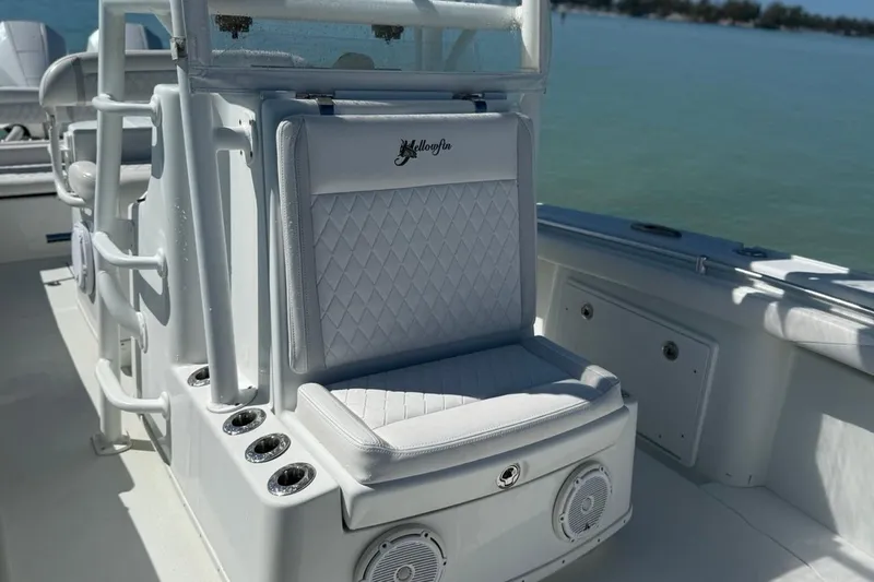 Slide: The Image of 2017 Yellowfin 26 Hybrid boat interior with cushioned seating and rod holders. - 10