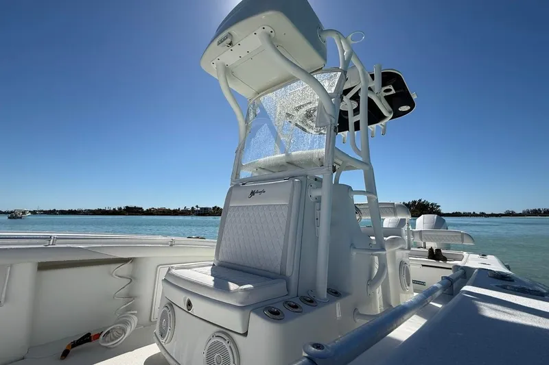 Slide: The Image of 2017 Yellowfin 26 Hybrid boat on calm water, featuring sleek design and modern amenities. - 14