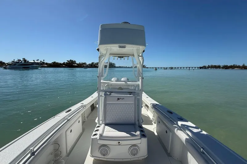 Slide: The Image of 2017 Yellowfin 26 Hybrid boat on calm water with clear blue sky. - 15