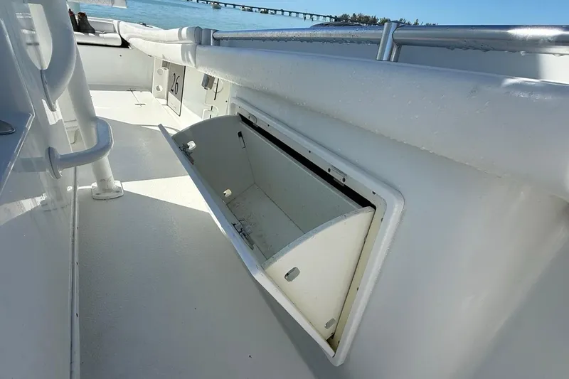 Slide: The Image of 2017 Yellowfin 26 Hybrid boat interior with open storage compartment, ocean view. - 17