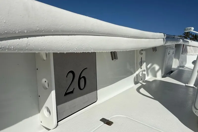 Slide: The Image of 2017 Yellowfin 26 Hybrid boat interior with number 26, featuring sleek white design. - 21