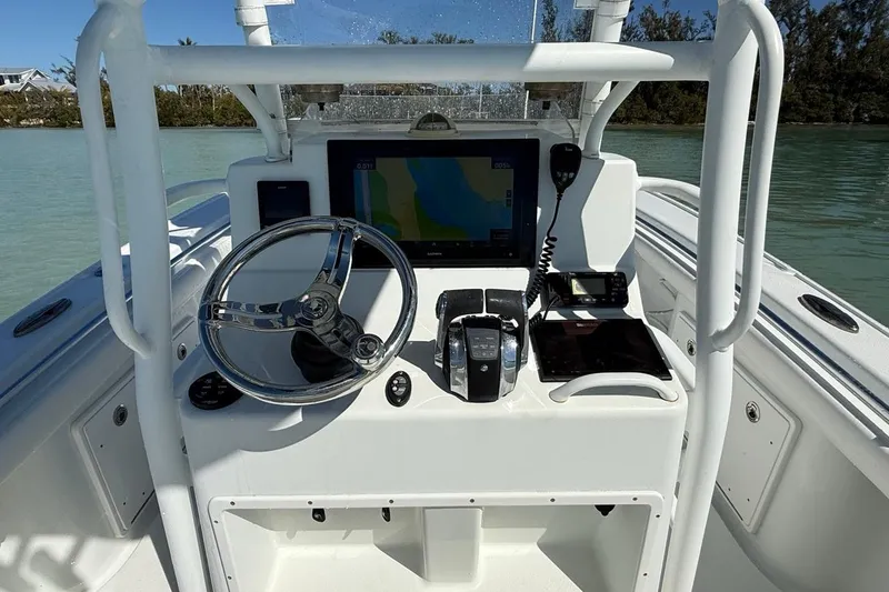 Slide: The Image of 2017 Yellowfin 26 Hybrid boat console with steering wheel and navigation equipment. - 22