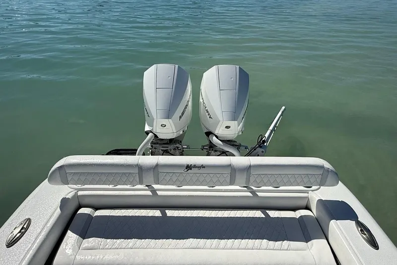 Slide: The Image of 2017 Yellowfin 26 Hybrid boat with twin Mercury engines on calm water. - 27