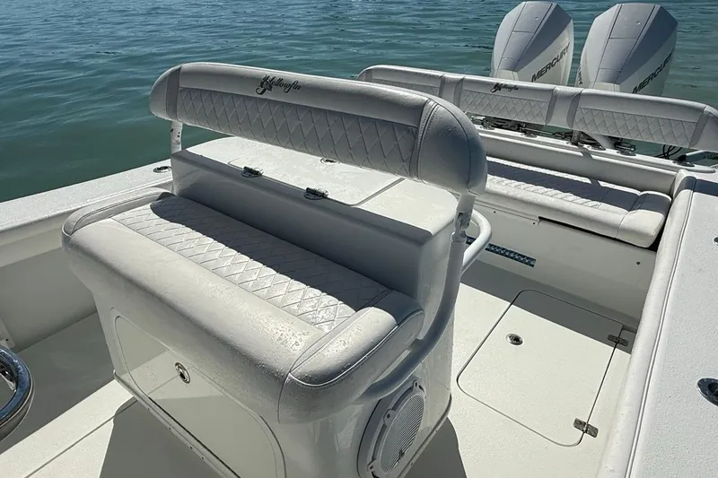 Slide: The Image of 2017 Yellowfin 26 Hybrid boat interior with cushioned seating and dual Mercury engines. - 29
