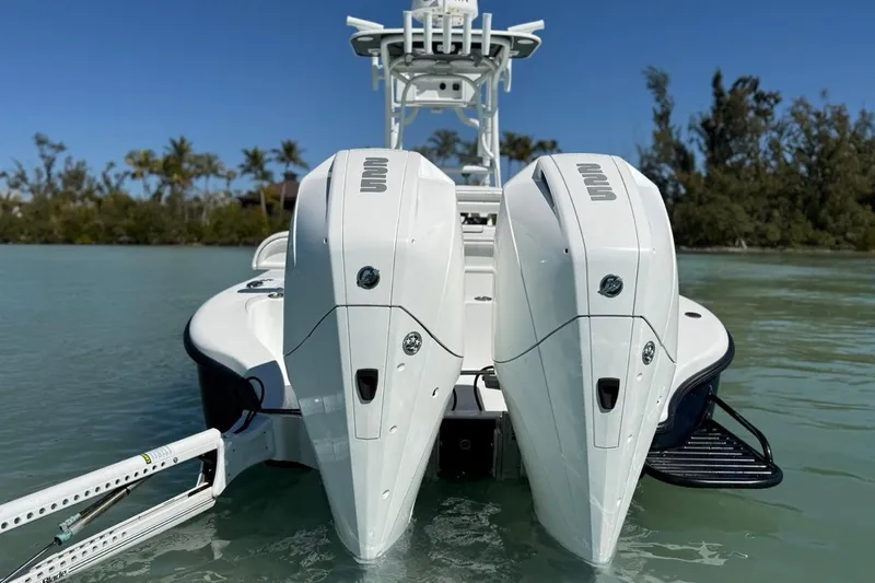 Slide: The Image of 2017 Yellowfin 26 Hybrid boat with dual outboard engines on calm water. - 30