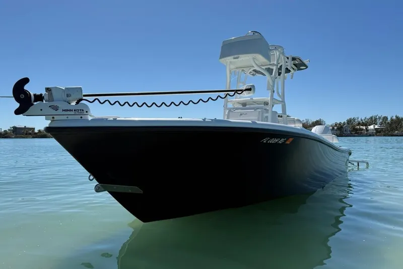 Slide: The Image of 2017 Yellowfin 26 Hybrid boat on calm water, featuring Minn Kota trolling motor. - 5