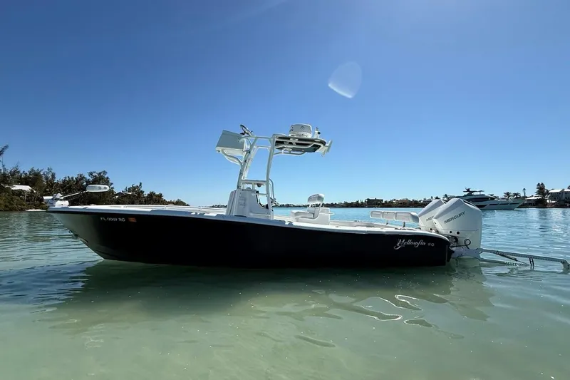 Slide: The Image of 2017 Yellowfin 26 Hybrid boat on calm water under clear blue sky. - 6