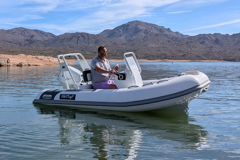 Slide: The Image of Manufacturer Provided Image: Man enjoying a ride on a 2025 Tide Craft Beaver 10 boat in a scenic lake. - 4