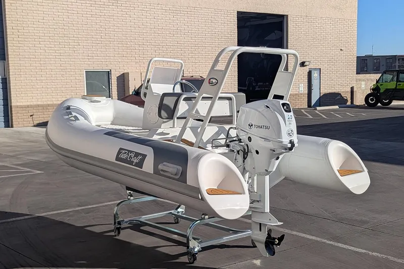Slide: The Image of Manufacturer Provided Image: 2025 Tide Craft Beaver 10 inflatable boat with Tohatsu motor in a parking lot. - 7