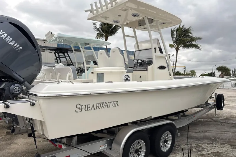 The Image of 2024 ShearWater 270 SS Open Carolina boat on trailer, featuring Yamaha engine. - 1
