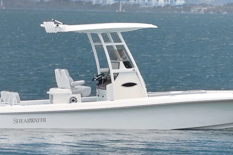 Slide: The Image of 2024 ShearWater 270 SS Open Carolina boat on calm blue water. - 10